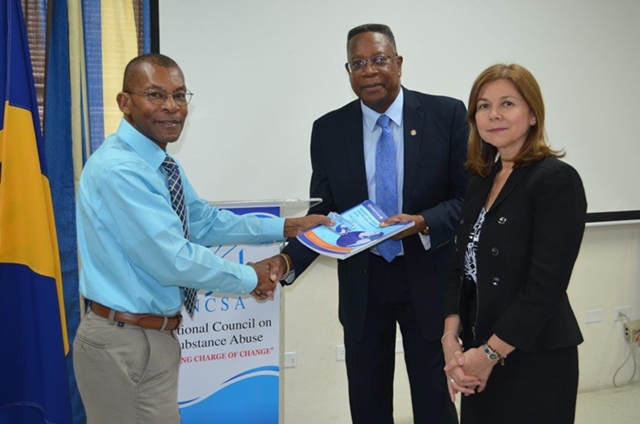 Presentation of the report, Drug Use  in the Americas 2019, to Hadford Howell,Chairman of the Board National Council on Substance, (NCSA) by OAS Country Representative Francis McBarnette as  Angela Crowdy, Assistant Executive Secretary of OAS CICAD looks on at the NCSA HQ May 22,2019(May 22, 2019)